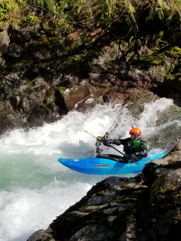 2021 Pyranha Scorch whitewater kayak paddled by Nick Hinds wearing Stohlquist PFD as he boofs on Canyon Creek of the Lewis river in WA