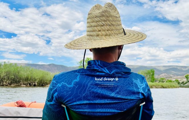 Kind Design sun shirt sitting on raft with straw Flylow hat